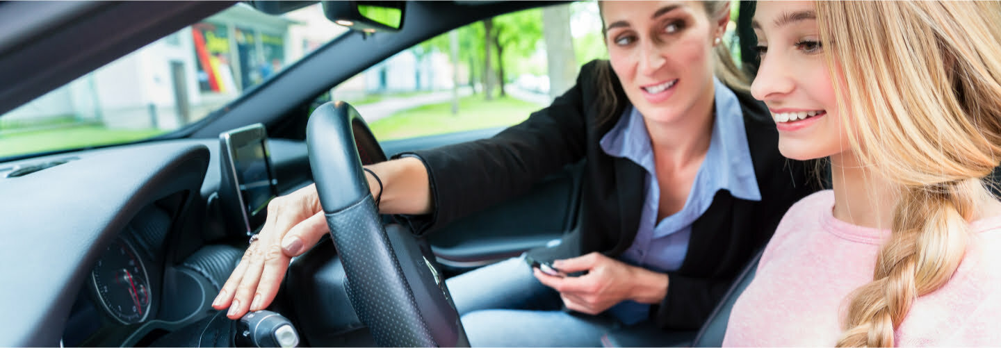 An image of a driving instructor showing a teen how to use turn signals when changing lanes at the Teen Behind The Wheel Program.